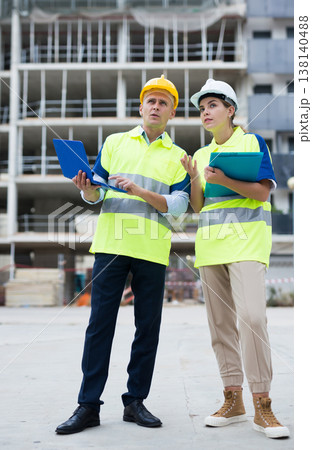 Two architects with laptop discussing construction plan Two architects with laptop discussing construction plan 138140488