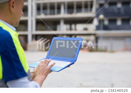 Engineer with laptop in construction site 138140520