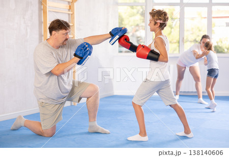 Father and son training boxing in studio Father and son training boxing in studio 138140606