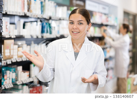 Friendly female pharmacist invites you to visit pharmacy or store of healing cosmetics 138140607