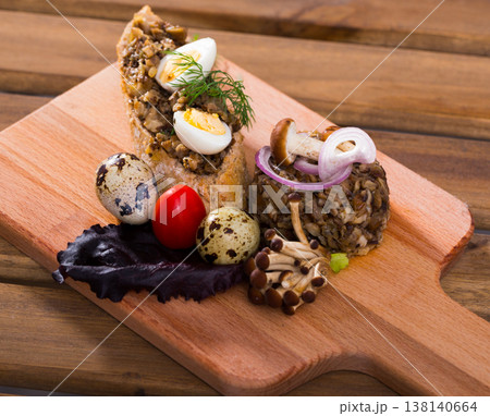 Tasty pate from button mushrooms with quail egg, onions and greens 138140664
