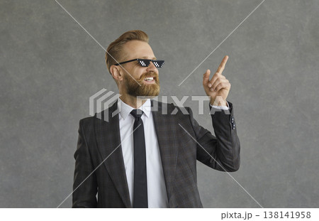 Portrait of a successful cool businessman in funny pixel glasses on a gray background. Portrait of a successful cool businessman in funny pixel glasses on a gray background. 138141958