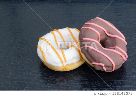 Donuts in close-up on a wooden background Donuts in close-up on a wooden background 138142073