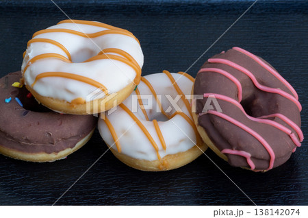Donuts in close-up on a wooden background Donuts in close-up on a wooden background 138142074