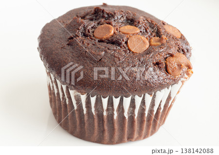 Freshly baked chocolate muffins stacked surface with chocolate chunks beside them on a transparent background Freshly baked chocolate muffins stacked surface with chocolate chunks beside them on a transparent background 138142088