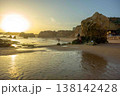 Golden hour idyllic vacation beach scene Algarve Portugal Praia do Amado big sun 138142428
