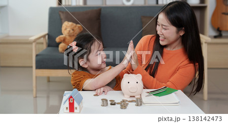 Mother and daughter celebrating financial learning 138142473