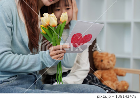Mother's Day celebration with a handmade card and flowers Mother's Day celebration with a handmade card and flowers 138142478