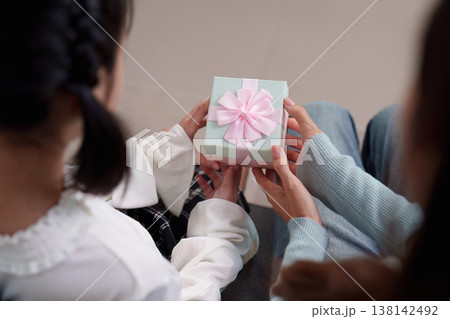 Mother and daughter exchanging a gift on Mother's Day 138142492