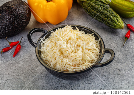 Steamed long-grain white rice in a bowl on a gray textured background. Steamed long-grain white rice in a bowl on a gray textured background. 138142561