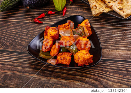 Indian Paneer Tikka Masala inl with Roti bread on a dark wooden table Indian Paneer Tikka Masala inl with Roti bread on a dark wooden table 138142564