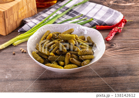 Rustic still life with a bowl of pickled gherkins, green onions, and chili peppers on a wooden table Rustic still life with a bowl of pickled gherkins, green onions, and chili peppers on a wooden table 138142612