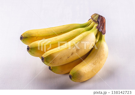 Fresh bunch of ripe yellow bananas isolated on a white background Fresh bunch of ripe yellow bananas isolated on a white background 138142723