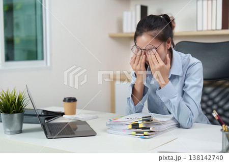 Office syndrome concept with woman rubbing eyes at desk Office syndrome concept with woman rubbing eyes at desk 138142740