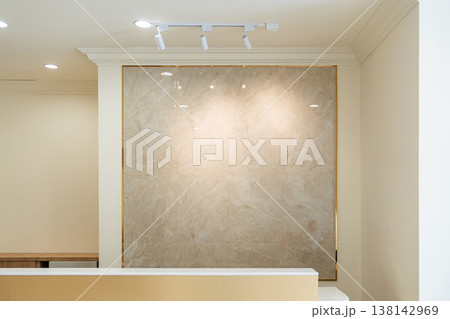 Minimal luxury interior with a marble wall and soft lighting in a modern architectural space creating a refined and elegant atmosphere. 138142969
