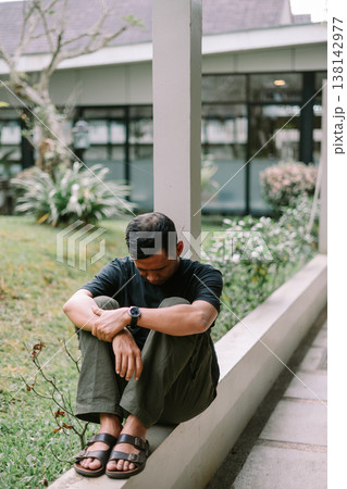 Asian Man Sitting and Looking Away Feeling Lost and Emotional Asian Man Sitting and Looking Away Feeling Lost and Emotional 138142977
