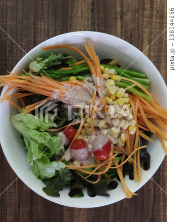 Fresh Mixed Vegetable Salad with Carrot Strips, Corn, Lettuce, Cherry Tomatoes, and Leafy Greens Served in a White Bowl Fresh Mixed Vegetable Salad with Carrot Strips, Corn, Lettuce, Cherry Tomatoes, and Leafy Greens Served in a White Bowl 138144256