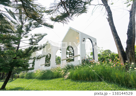 Modern Minimalist White Gable Houses on Green Hillside Garden 138144529