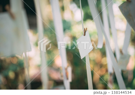 Multiple Blank Card Mockups Hanging on Ribbon for Wedding Event Decoration Multiple Blank Card Mockups Hanging on Ribbon for Wedding Event Decoration 138144534
