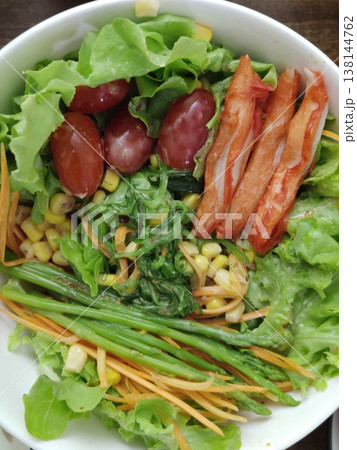 Fresh Mixed Salad Bowl with Lettuce, Crab sticks, Carrot Strips, Corn, Leafy Greens, and Assorted Vegetables Arranged in a White Round Dish Fresh Mixed Salad Bowl with Lettuce, Crab sticks, Carrot Strips, Corn, Leafy Greens, and Assorted Vegetables Arranged in a White Round Dish 138144762