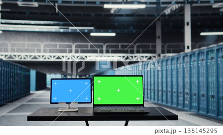 Chroma key devices in high tech data center facility with rows of server rigs infrastructure. Isolated screen tablet and laptop used to oversee server room built for digital storage mainframes Chroma key devices in high tech data center facility with rows of server rigs infrastructure. Isolated screen tablet and laptop used to oversee server room built for digital storage mainframes 138145295