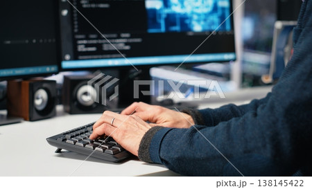 Admin in high tech data center coding with machine learning generative AI assistant. Worker using artificial intelligence neural networks large language model technology, camera A 138145422