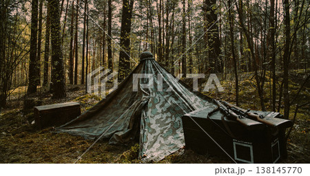 WWII German military camp with Zeltbahn tent and ammo crates in forest 138145770