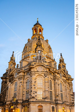 The Frauenkirche stands tall in Dresden, Germany, showcasing its large dome and intricate details. The scene highlights the church's architecture against a clear evening sky. The Frauenkirche stands tall in Dresden, Germany, showcasing its large dome and intricate details. The scene highlights the church's architecture against a clear evening sky. 138145876
