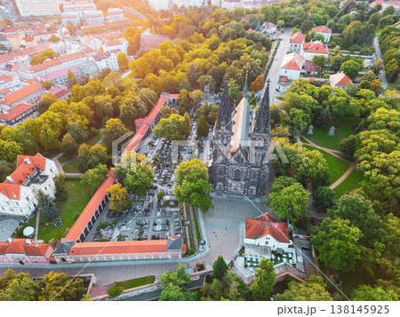 Vysehrad Basilica of St. Peter and St. Paul rises majestically amid lush greenery during a golden sunrise in Prague, showcasing Gothic architecture and serene surroundings. Vysehrad Basilica of St. Peter and St. Paul rises majestically amid lush greenery during a golden sunrise in Prague, showcasing Gothic architecture and serene surroundings. 138145925