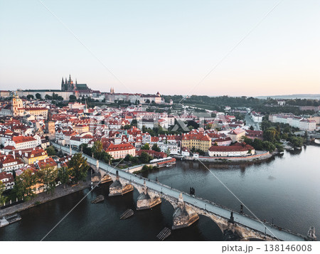 Morning light bathes Prague in warmth, highlighting the beautiful architecture along the Vltava River. The Charles Bridge connects historical features, creating a picturesque panorama of the city. Morning light bathes Prague in warmth, highlighting the beautiful architecture along the Vltava River. The Charles Bridge connects historical features, creating a picturesque panorama of the city. 138146008
