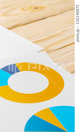 Colorful pie chart design on plain paper resting on wooden table Colorful pie chart design on plain paper resting on wooden table 138146875