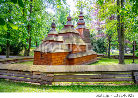 St. Nicholas church stands in Jiraskovy orchards, Hradec Kralove. This wooden structure dates back to the 16th century and was moved here in the 20th century. It is surrounded by trees. 138146928
