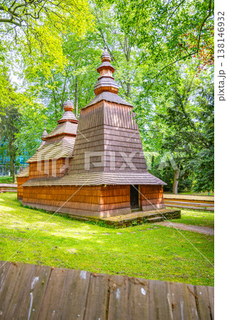 Wooden church from the 16th century stands in Jiraskovy orchards in Hradec Kralove. This structure was moved to its current location in the 20th century. Trees surround the building. Wooden church from the 16th century stands in Jiraskovy orchards in Hradec Kralove. This structure was moved to its current location in the 20th century. Trees surround the building. 138146932