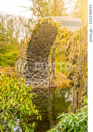 Rakotz Bridge gracefully arches over calm waters, mirrored perfectly against a backdrop of fall foliage. Germany Rakotz Bridge gracefully arches over calm waters, mirrored perfectly against a backdrop of fall foliage. Germany 138146935
