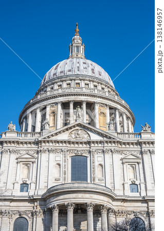 St Pauls Cathedral is located in London, United Kingdom. The dome is visible and clearly shows architectural details. The sky is bright and clear, enhancing the view of the building. 138146957