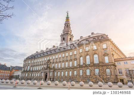 Visitors walk around Christiansborg Palace in Copenhagen, Denmark. The palace serves as a government building and is located on the Slotsholmen islet. Many people admire the historic architecture. 138146988