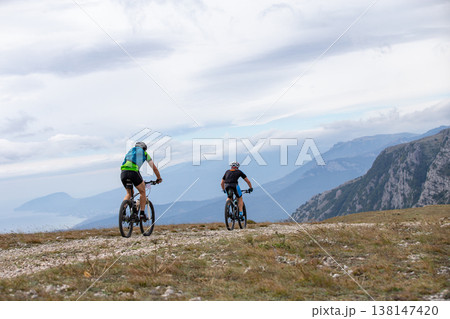 Two mountain bikers riding on rocky terrain 138147420