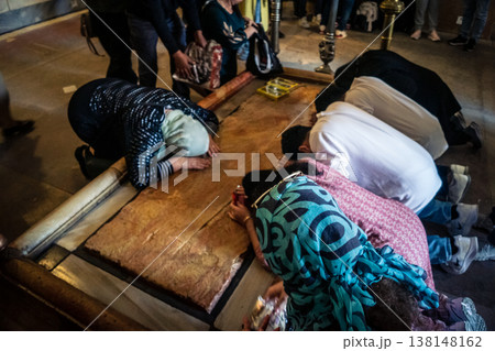Christian pilgrims on the Stone of Anointing, Holy Sepulchre in Jerusalem. Christian pilgrims on the Stone of Anointing, Holy Sepulchre in Jerusalem. 138148162