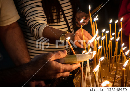 Christian pilgrims lighting candles in the Holy Sepulchre in Jerusalem. Christian pilgrims lighting candles in the Holy Sepulchre in Jerusalem. 138148470