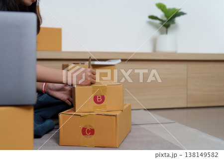 Woman preparing parcels for shipping Woman preparing parcels for shipping 138149582