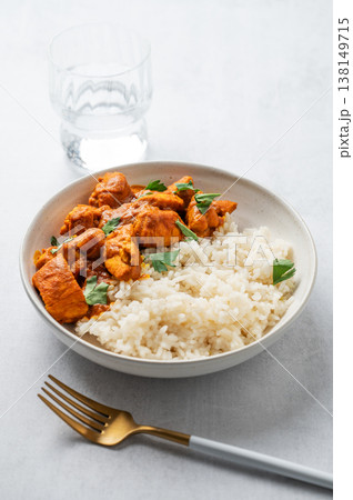 Chicken tikka masala curry with rice on light concrete background Chicken tikka masala curry with rice on light concrete background 138149715