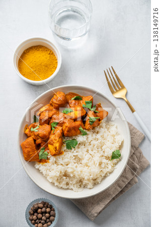 Chicken tikka masala curry with rice on light concrete background Chicken tikka masala curry with rice on light concrete background 138149716