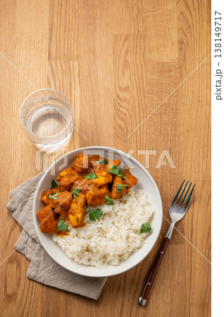 Chicken tikka masala curry with rice on wooden background Chicken tikka masala curry with rice on wooden background 138149717