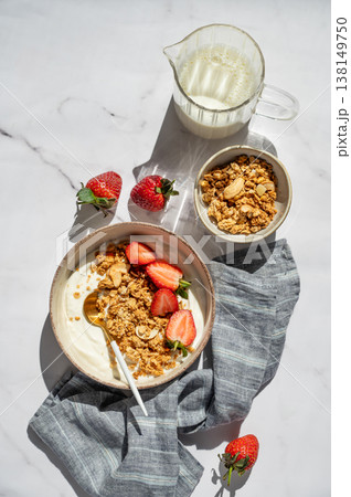 Balanced breakfast with yogurt, granola and strawberry on marble background. Top view Balanced breakfast with yogurt, granola and strawberry on marble background. Top view 138149750