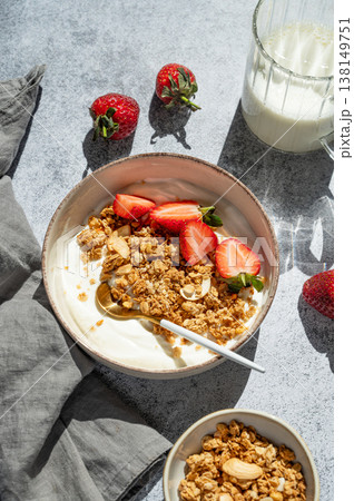 Balanced breakfast with yogurt, granola and strawberry on concrete background. Top view Balanced breakfast with yogurt, granola and strawberry on concrete background. Top view 138149751