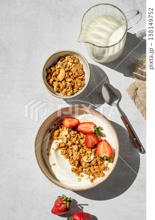 Balanced breakfast with yogurt, granola and strawberry on light background. Top view Balanced breakfast with yogurt, granola and strawberry on light background. Top view 138149752