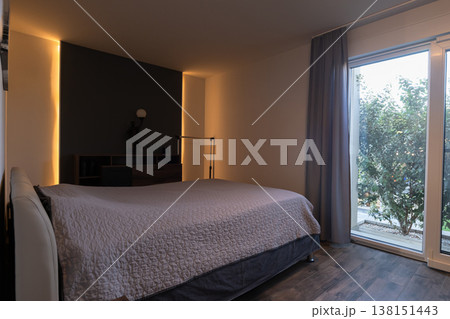 Modular house bedroom interior with smart home robot vacuum and warm sunset ambient lighting 138151443