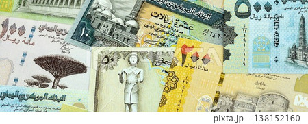 Yemeni rial paper banknotes pile on table. Yemen YER currency money bills in big amount. Concept of economics, taxation and banking in Yemen Yemeni rial paper banknotes pile on table. Yemen YER currency money bills in big amount. Concept of economics, taxation and banking in Yemen 138152160