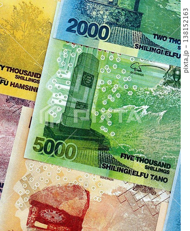 Ugandan shilling paper banknotes pile on table. Uganda UGX currency money bills in big amount. Concept of economics, taxation and banking in Uganda Ugandan shilling paper banknotes pile on table. Uganda UGX currency money bills in big amount. Concept of economics, taxation and banking in Uganda 138152163