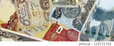 Iraqi dinar paper banknotes pile on table. Iraq IQD currency money bills in big amount. Concept of economics, taxation and banking in Iraq Iraqi dinar paper banknotes pile on table. Iraq IQD currency money bills in big amount. Concept of economics, taxation and banking in Iraq 138152168